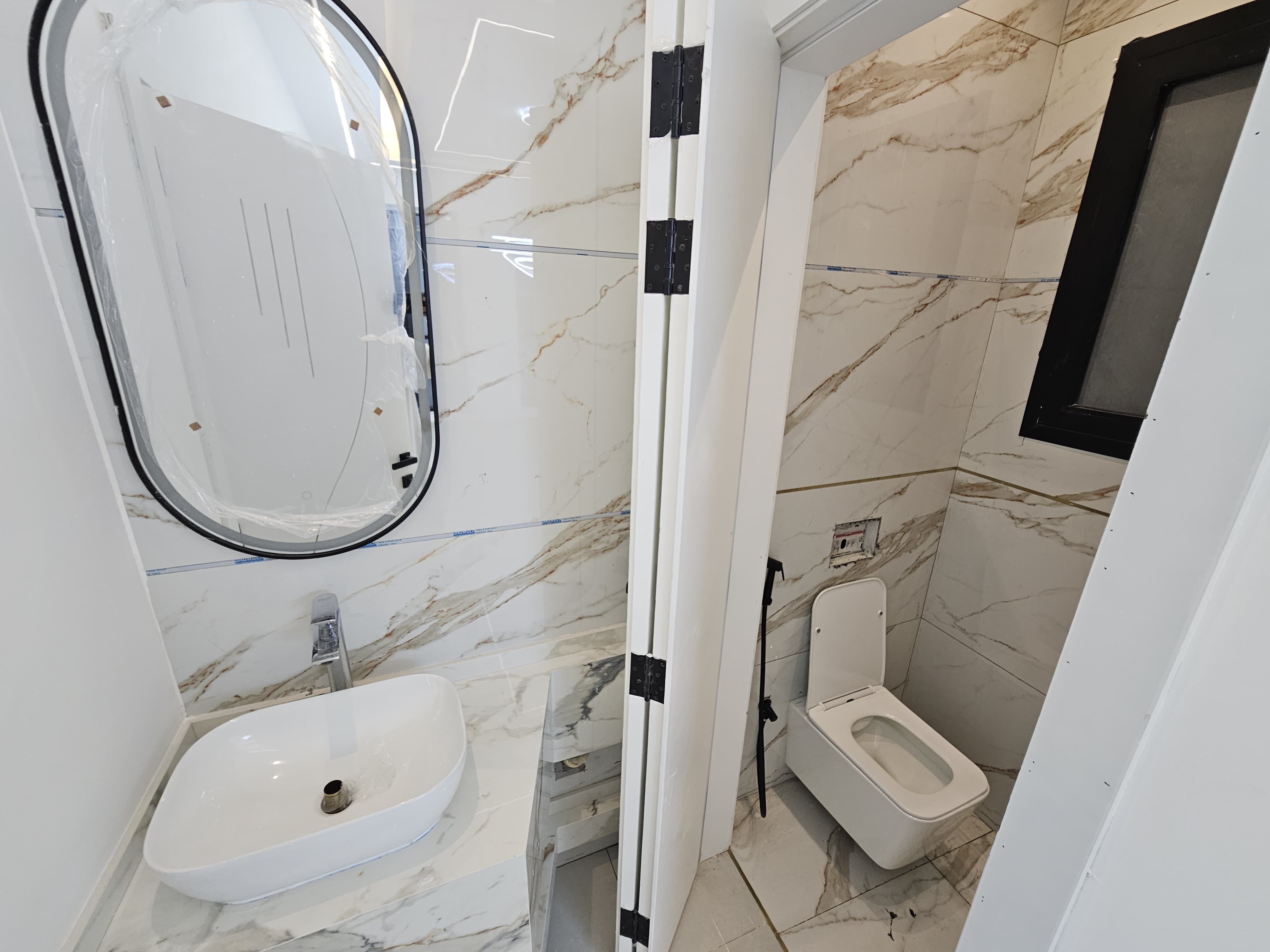 A residential villa is available on Al Zubair Street in Al Helio/2. It features luxurious modern finishes, natural stone and marble facades, distinctive lighting, and an interior design comprising a majlis, bathroom, washrooms, a large kitchen, a living room with a bathroom, four spacious master bedrooms with built-in wardrobes, and a balcony. The land area is 160 square meters (1722 square feet), and the built-up area is 3000 square feet (265 square meters). Registration and ownership fees are included. The asking price is AED 1,270,000. 10