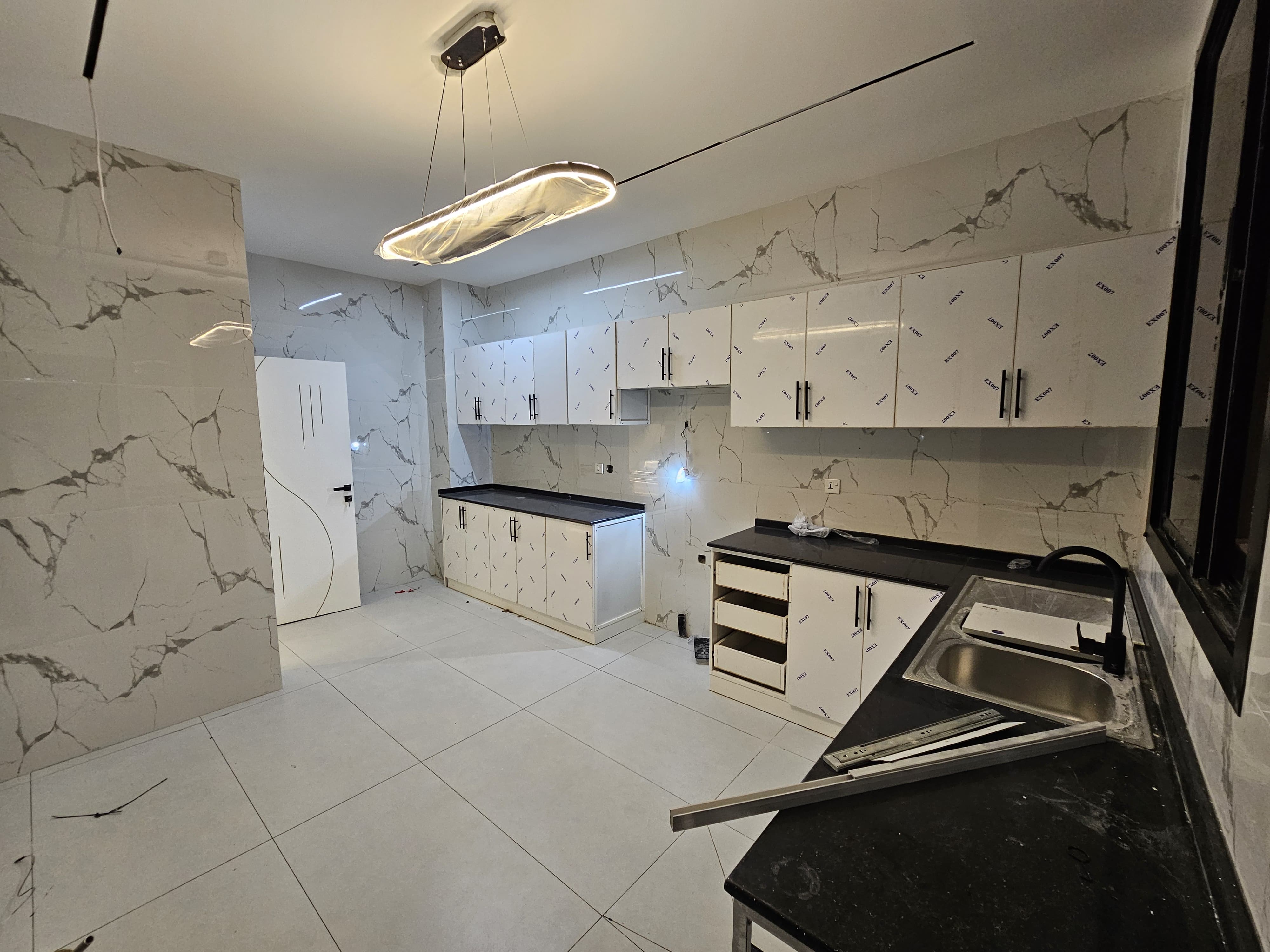 A residential villa is available on Al Zubair Street in Al Helio/2. It features luxurious modern finishes, natural stone and marble facades, distinctive lighting, and an interior design comprising a majlis, bathroom, washrooms, a large kitchen, a living room with a bathroom, four spacious master bedrooms with built-in wardrobes, and a balcony. The land area is 160 square meters (1722 square feet), and the built-up area is 3000 square feet (265 square meters). Registration and ownership fees are included. The asking price is AED 1,270,000. 11